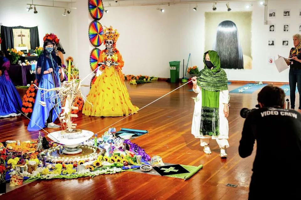 Festival of Altars participants circle the center altar while filming at the Mission Cultural Center for Latino Arts on Oct. 20, 2020, in San Francisco. (Noah Berger/Special to The Chronicle)