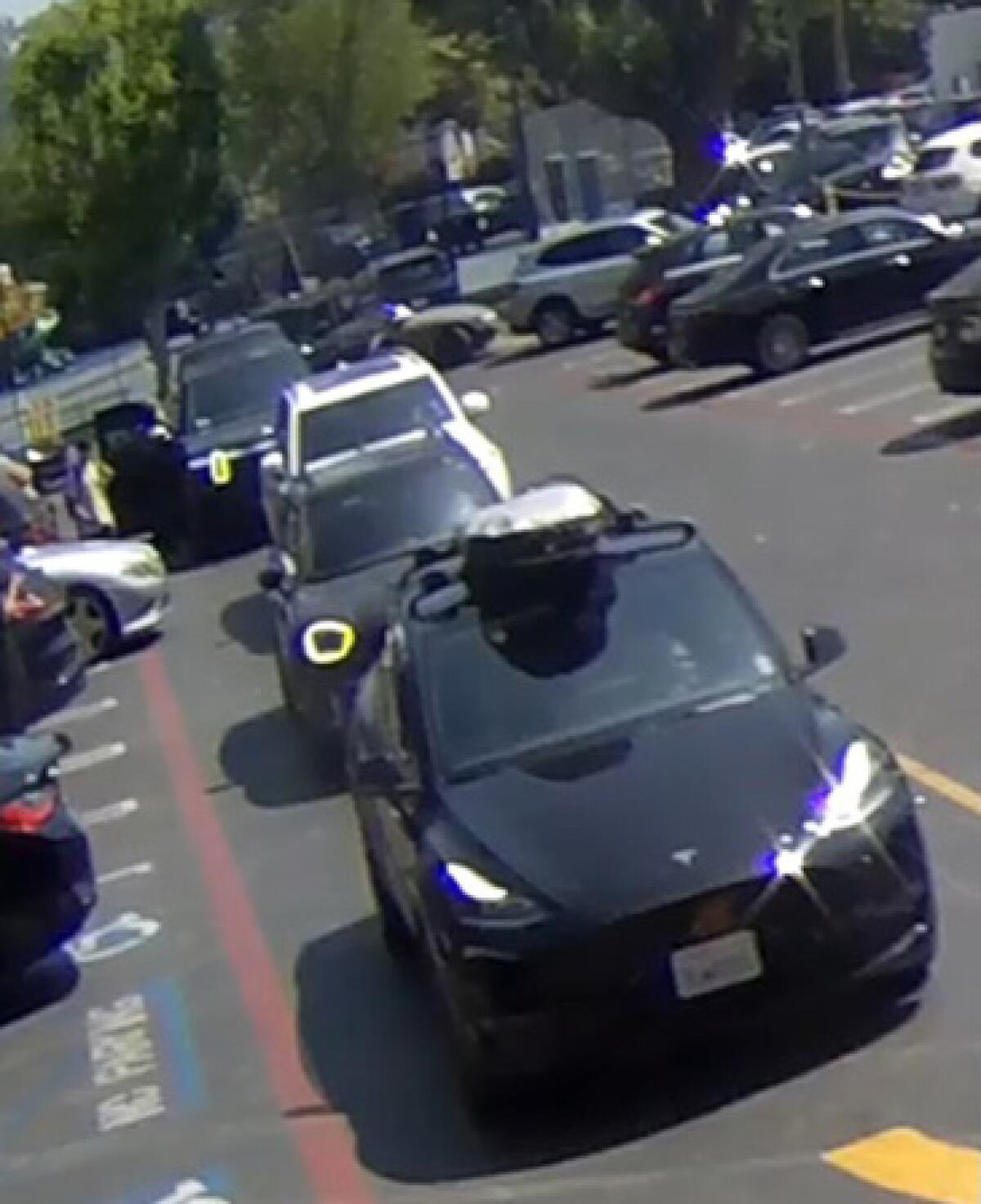Cars in a parking lot in an image from video.