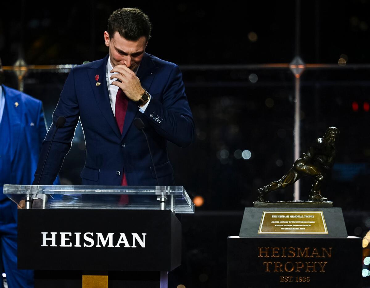 Indiana quarterback Fernando Mendoza holds back tears while accepting the Heisman Trophy on Dec. 13 in New York.