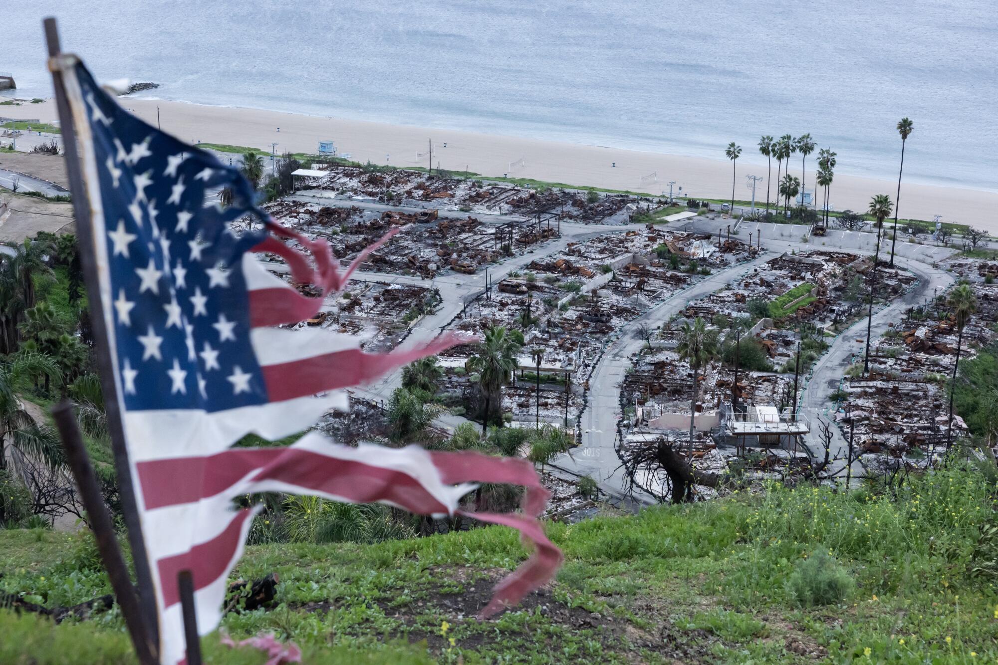 A tattered flag waves in the wind at Asilomar View Park overlooking the Pacific Palisades Bowl Mobile Estates.