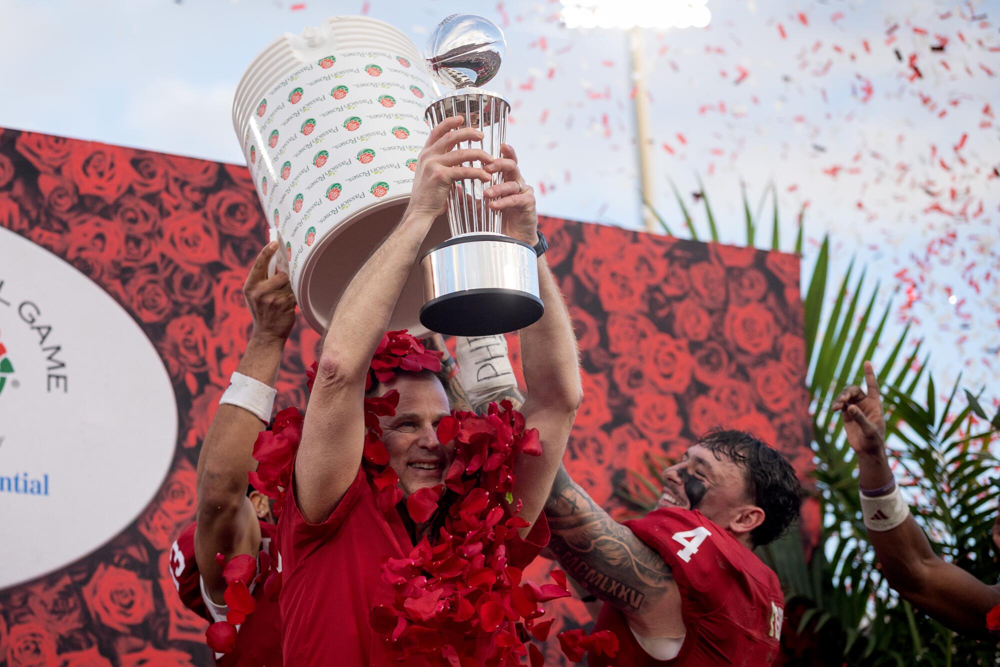 Indiana coach Curt Cignetti is showered in rose petals as he lifts the Leishman Trophy.