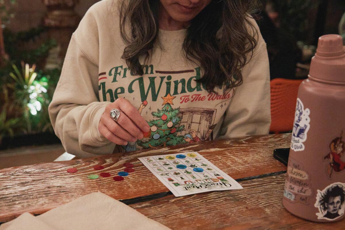 A serious woman watches her bingo card.