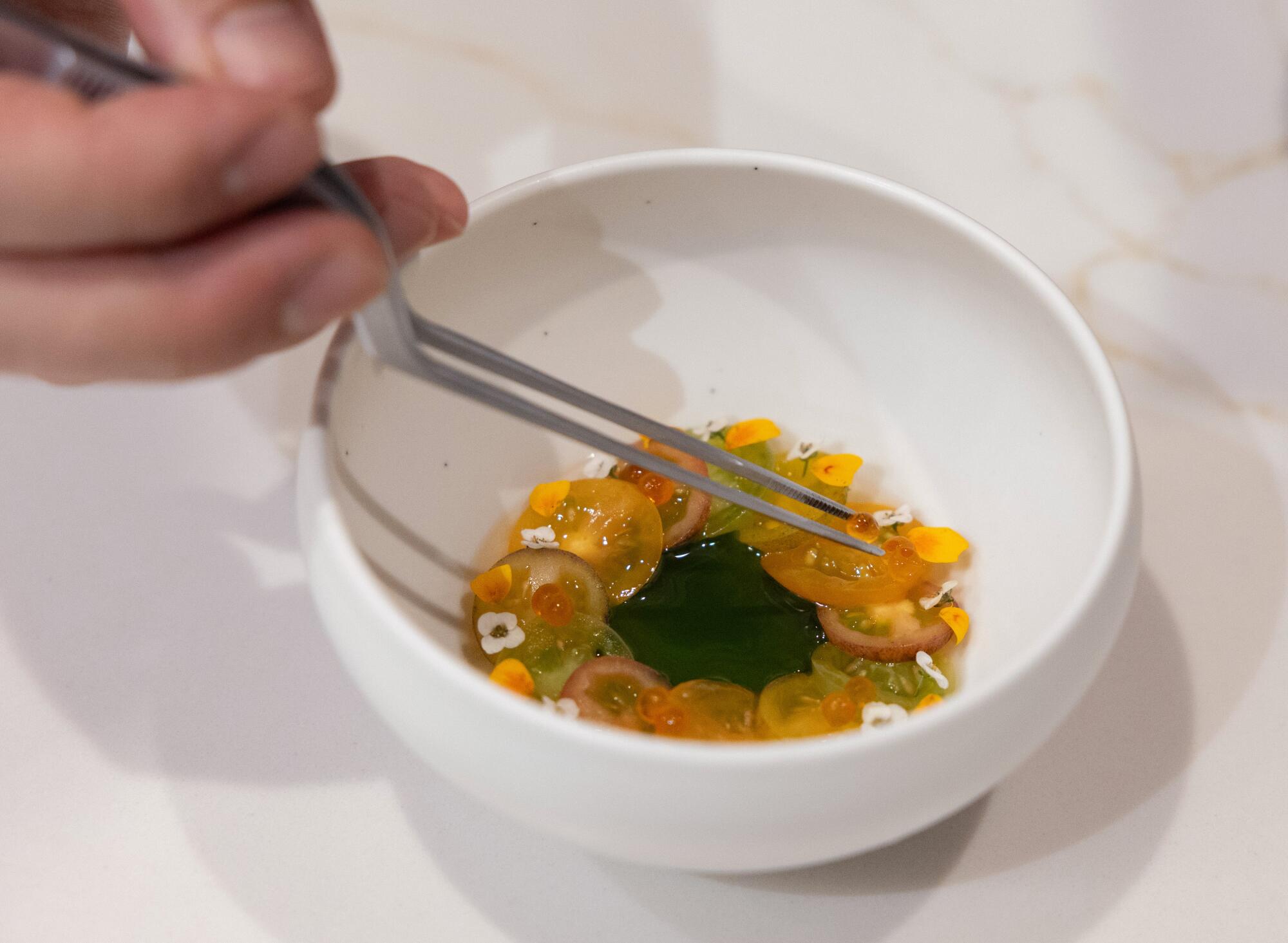 Smoked trout roe garnish for a dish of perilla leaf sorbet, smoked tomato and lemon fern at Restaurant Ki.