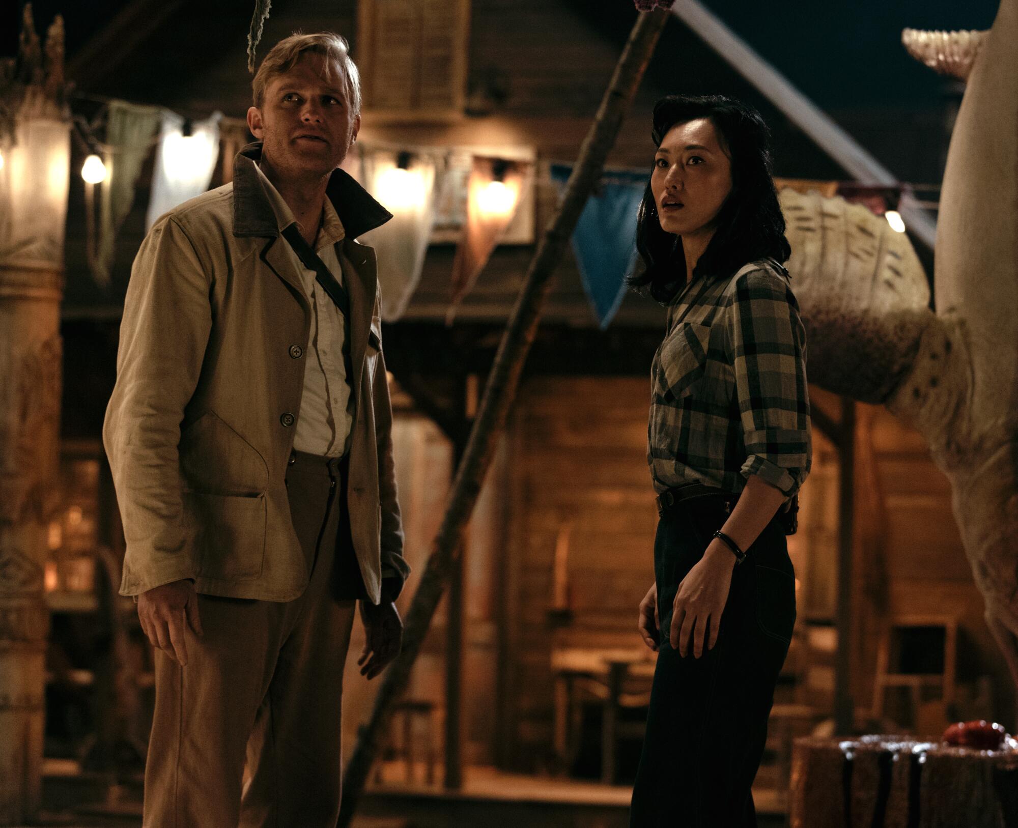 A man and woman standing looking at something unseen.