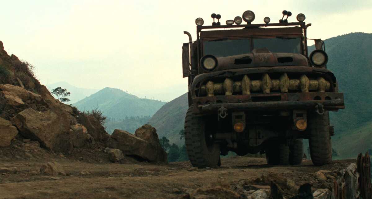 A truck drives at dawn.