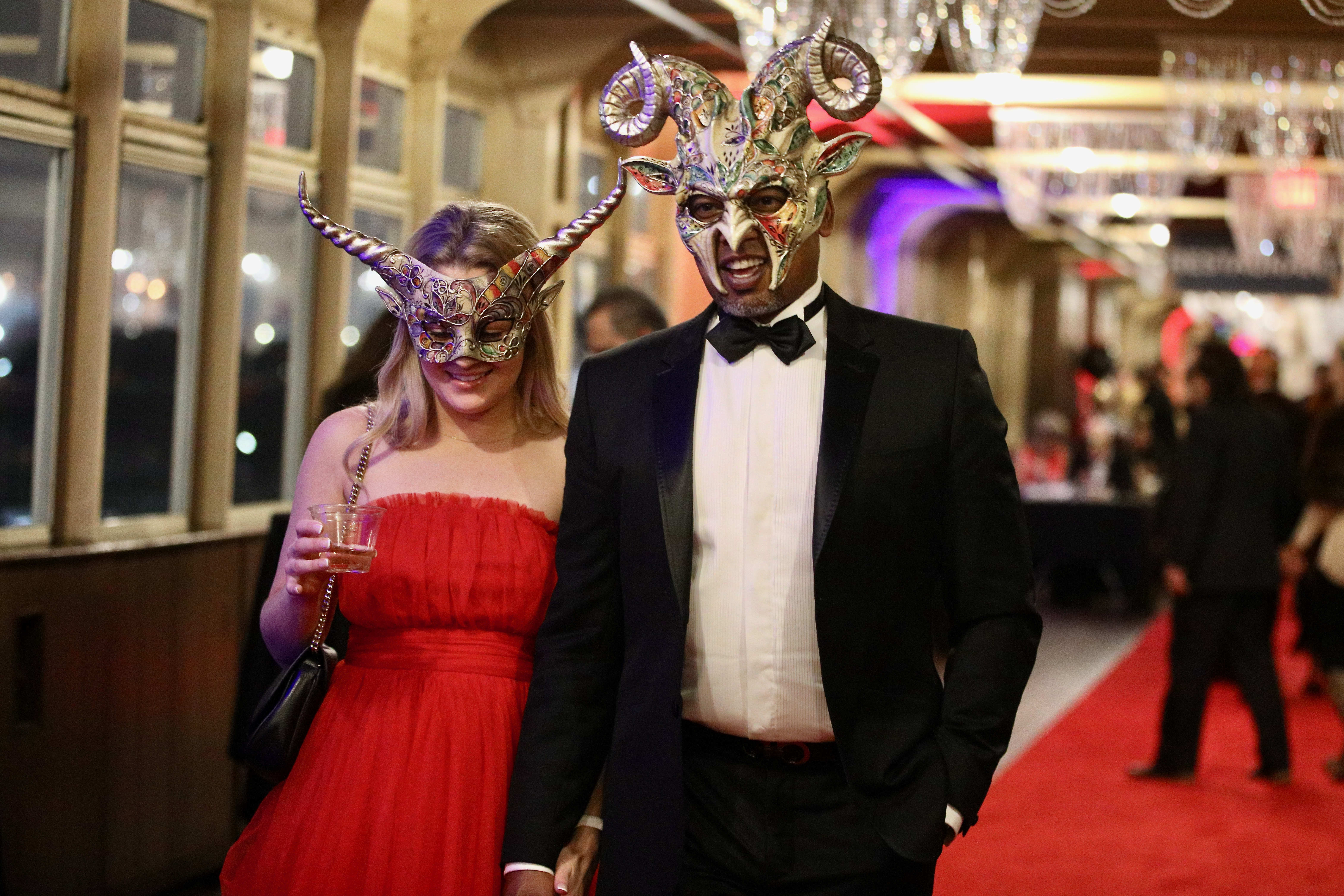 Masquerading revelers celebrate New Yearâs Eve aboard the Queen Mary...