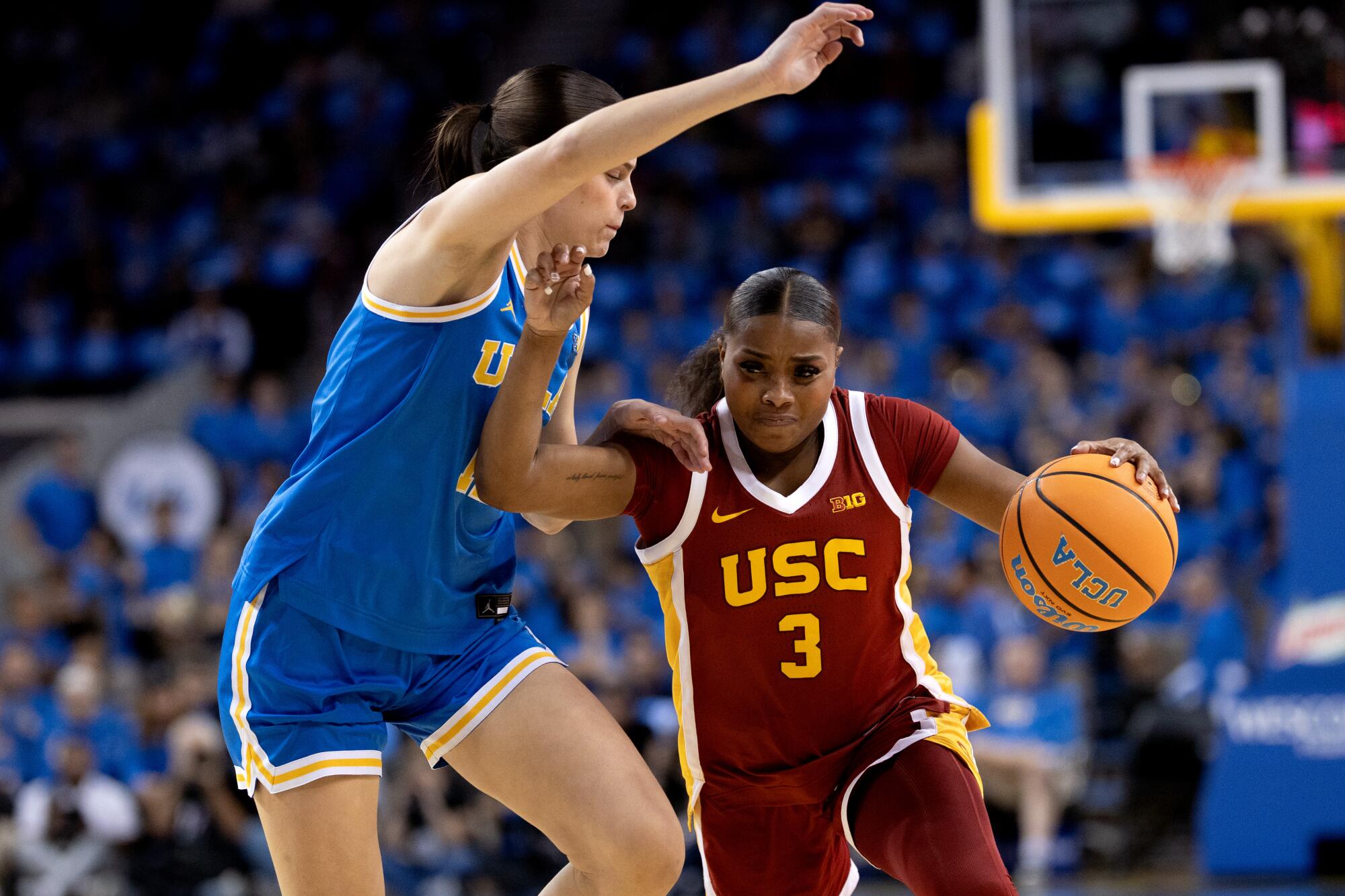 USC guard Londynn Jones tries to dive past UCLA forward Gabriela Jaquez at Pauley Pavilion on Saturday.