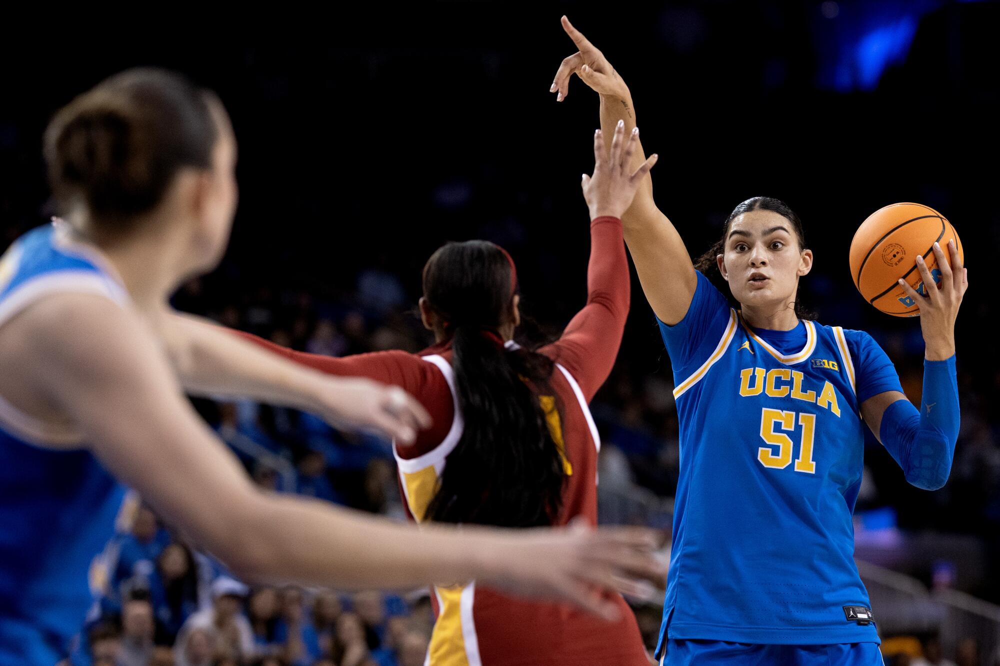 UCLA center Lauren Betts looks to pass to forward Angela Dugalic over USC guard Kennedy Smith during the second half.