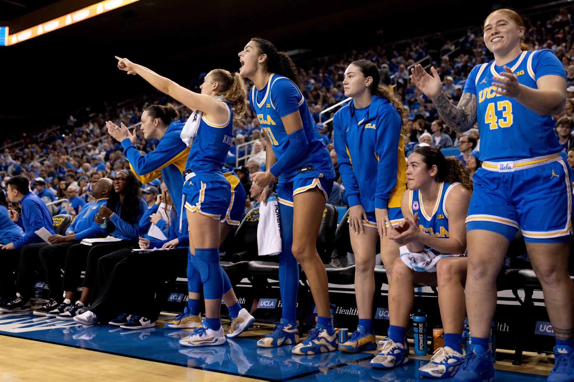 UCLA players celebrate on the bench during their 80-46 win over USC at Pauley Pavilion on Saturday night.