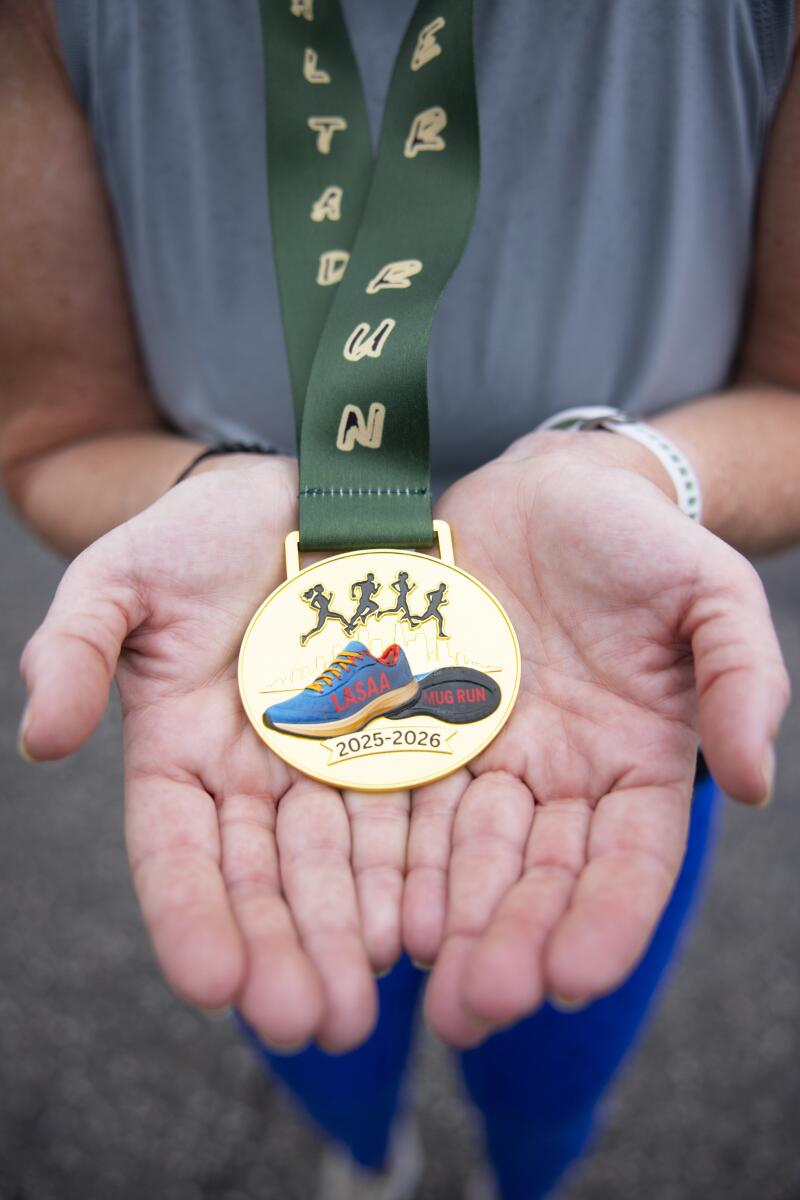 A close-up of a medal in a cupped pair of hands.