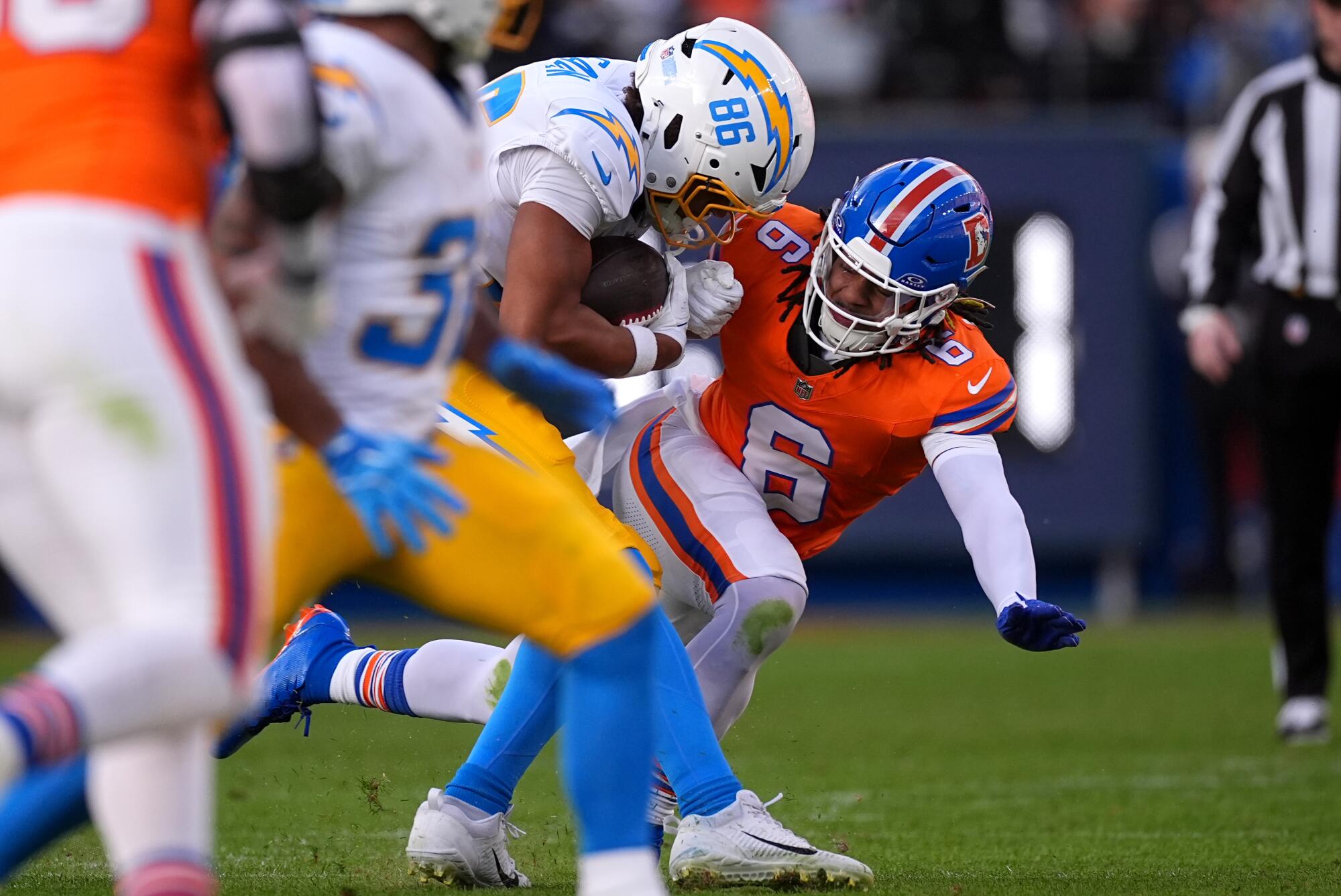 Chargers tight end Oronde Gadsden II catches a pass against Denver Broncos safety P.J. Locke during the first half Sunday.