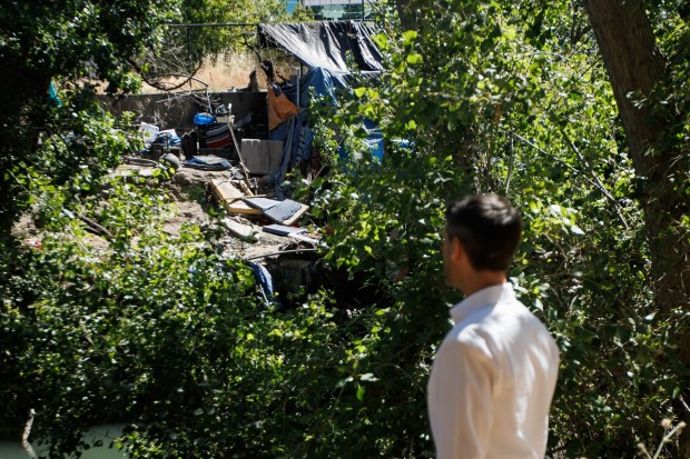 San Jose Mayor Matt Mahan looks at a homeless encampment as he hosts a walk-along at the Guadalupe River near Coleman Avenue in San Jose, Calif., on Monday, June 17, 2024. (Dai Sugano/Bay Area News Group)