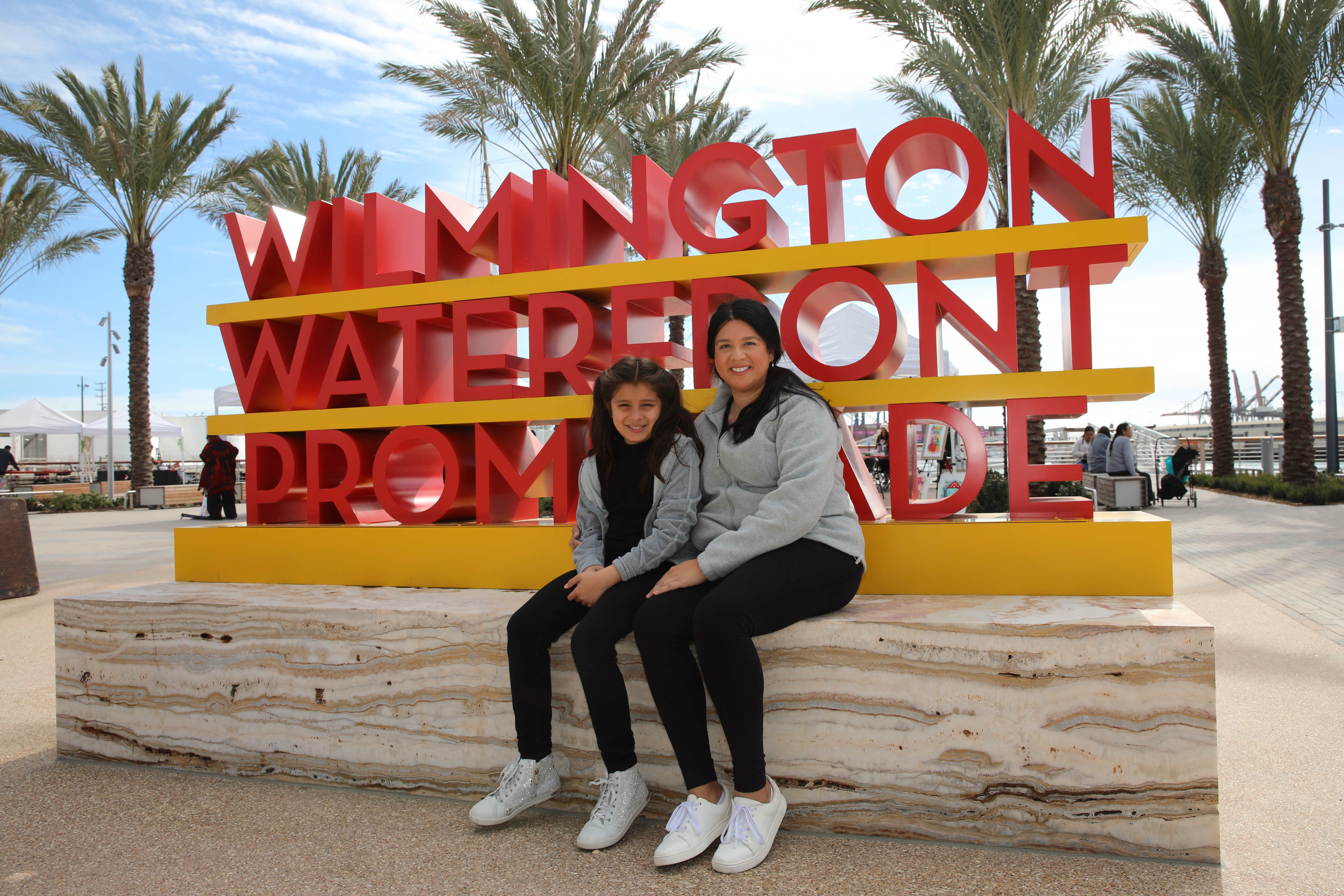 Local residents Marisol Varela and her daughter, Ada, 7, visit...