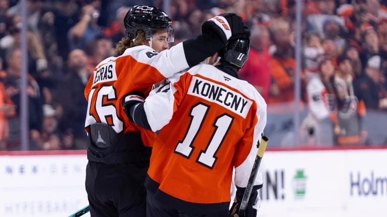 Philadelphia Flyers' Trevor Zegras, left, celebrates with Travis Konecny, right,...
