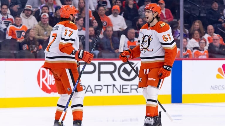 Anaheim Ducks' Cutter Gauthier, right, reacts to his goal with...