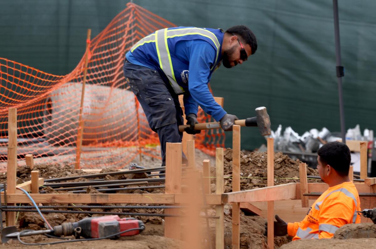A worker preparing the foundation for a home