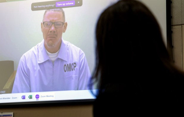 Charles "Andy" Williams, shown on a video monitor, weeps during a court hearing at the San Diego Central Courthouse downtown on Tuesday. (Sandy Huffaker / For The San Diego Union-Tribune)