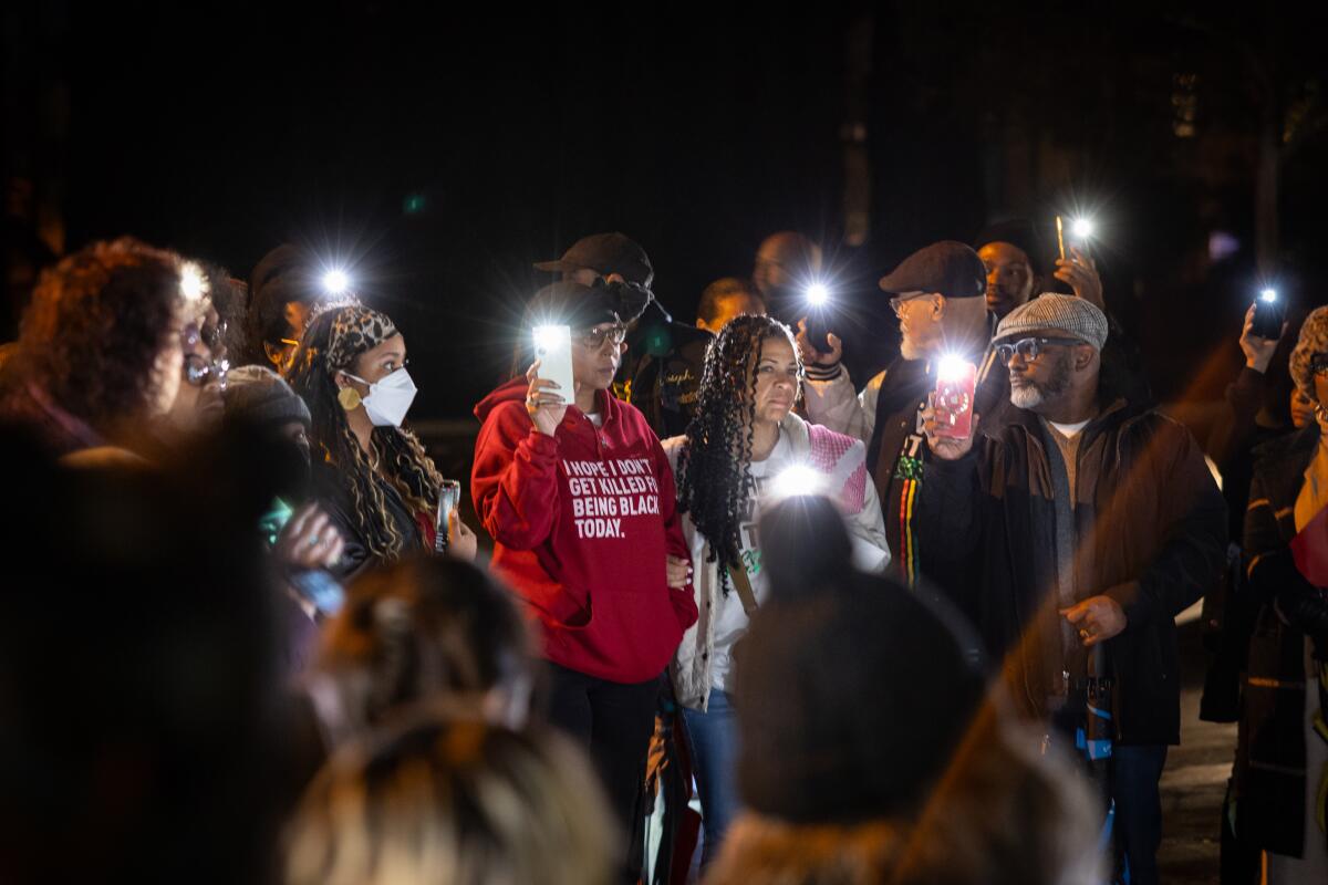 Community members gather at a vigil