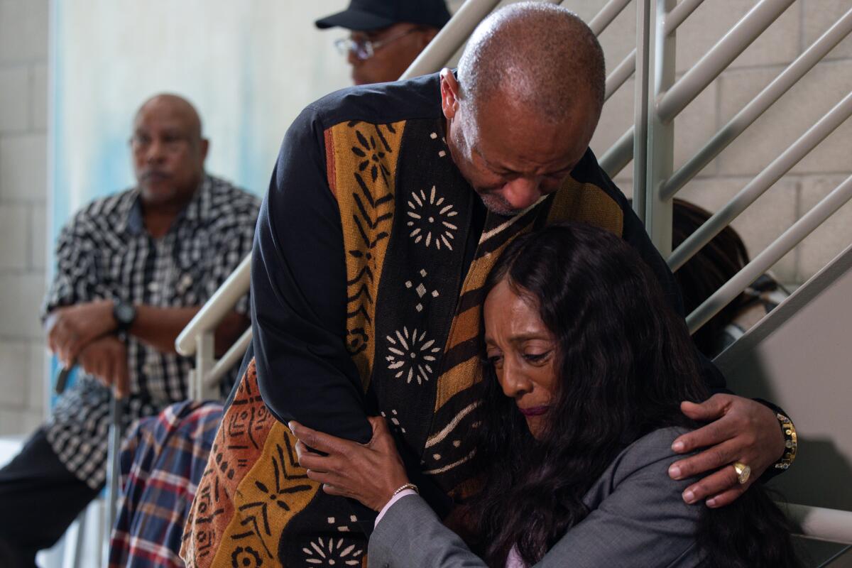 Activist Najee Ali embraces Keith Porter Jr.'s mother, Franceola Armstrong