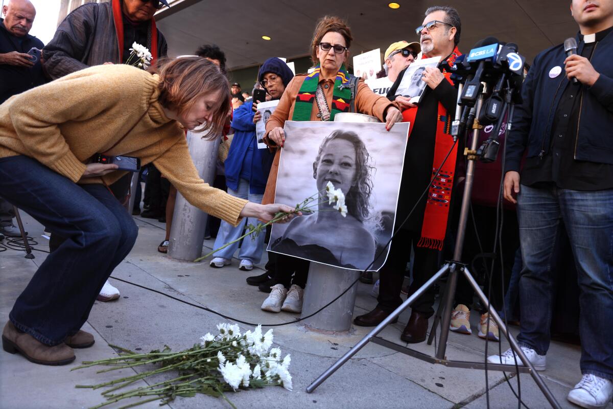 Protesters leave flowers in Good's memory after her shooting death by ICE