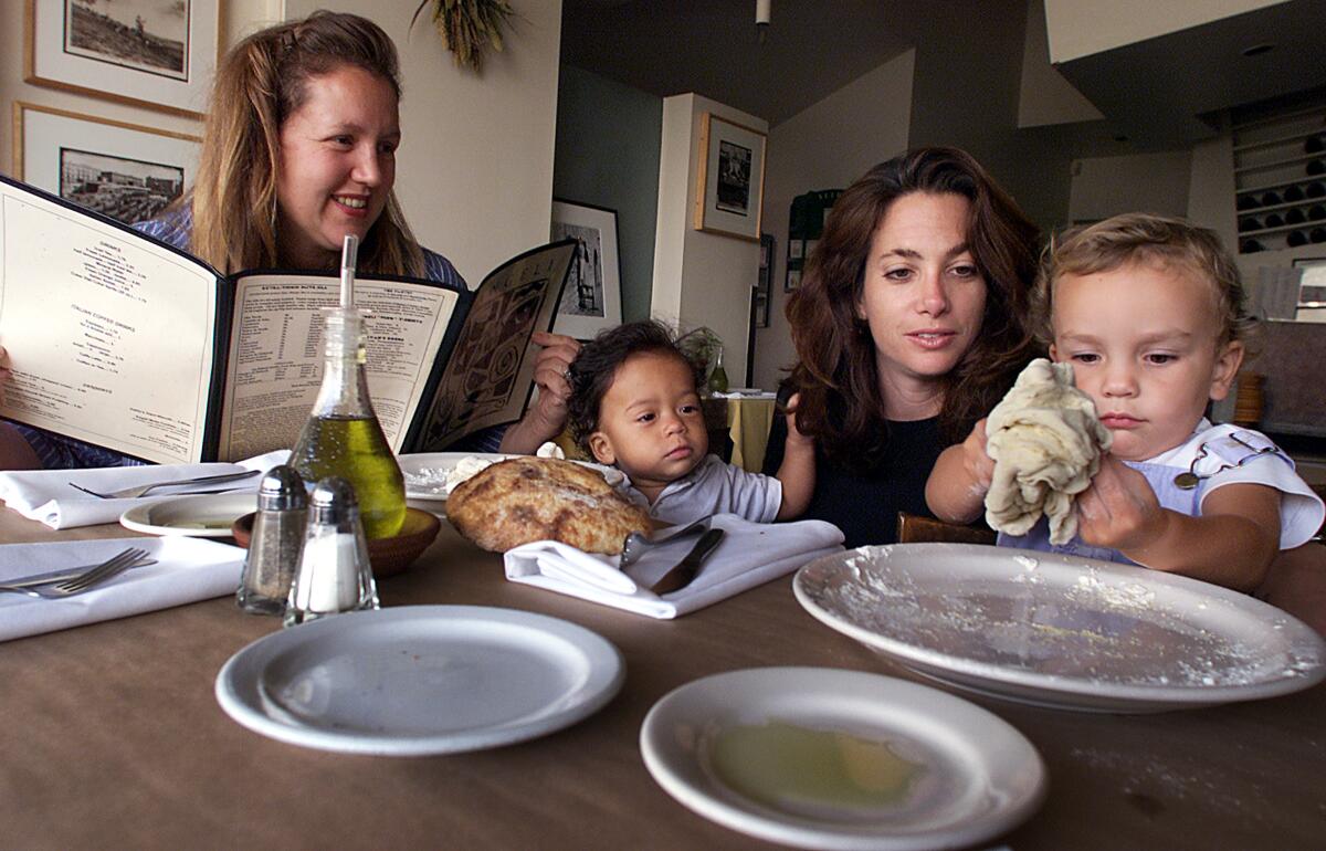 035458.CA.0907.edible.3.LS. Christine Moore, left, and Jennifer Ferro watch their children Kobe and Maddie at Angeli.