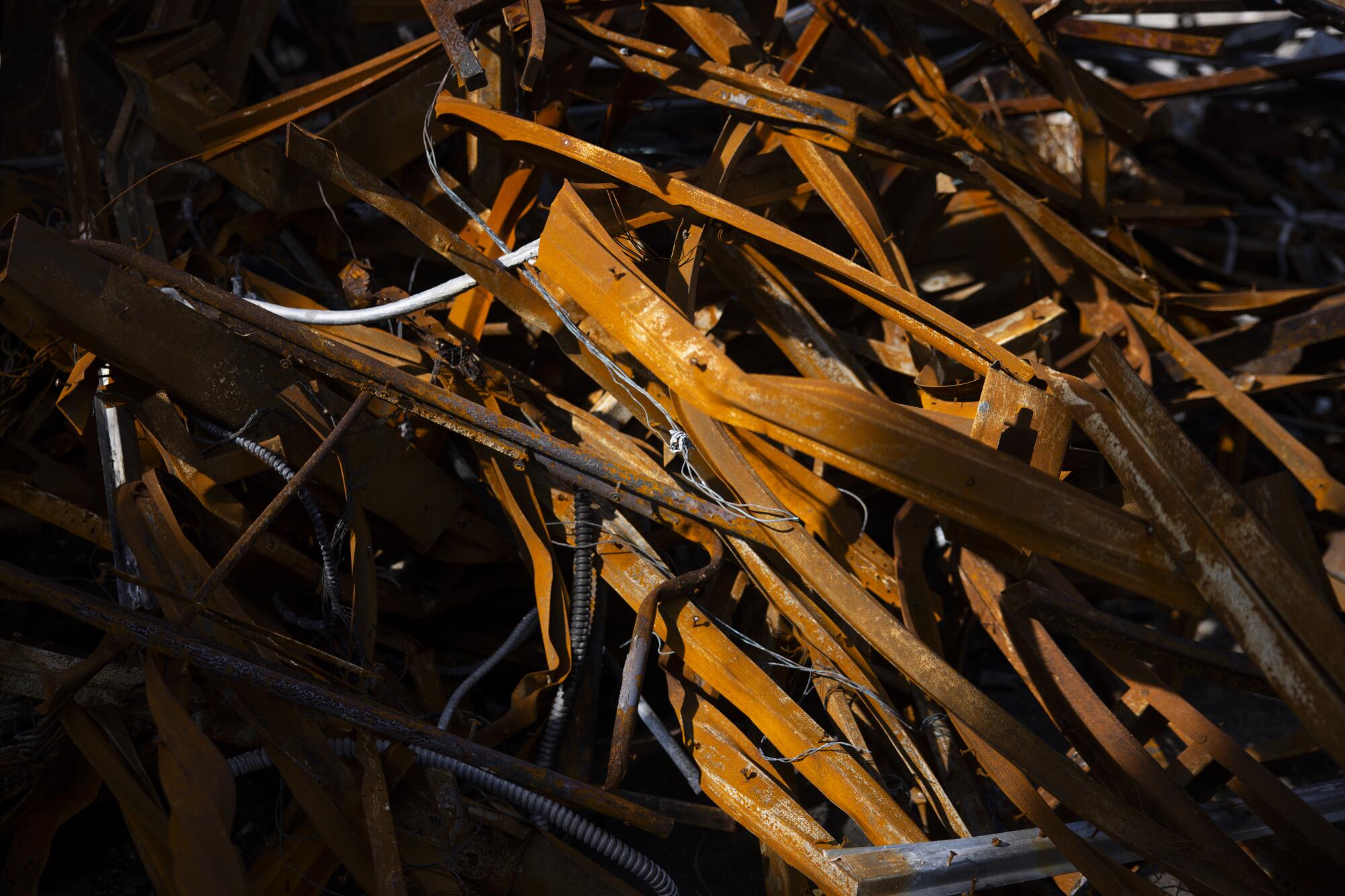 Twisted and scorched remnants of the the Pacific Palisades Business Block still are there a year after the fire.