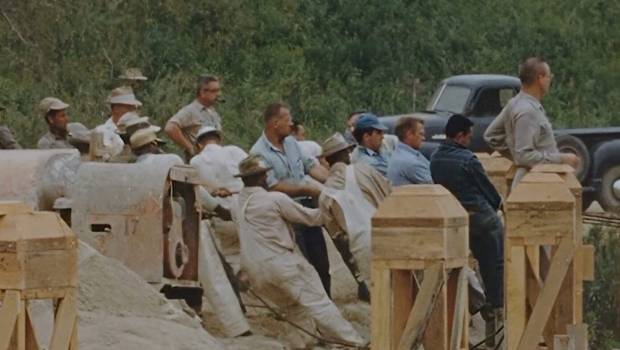 Workers use ropes to pull the Mark Twain Riverboat into position on the Rivers of America at Disneyland before the park opened in 1955. (Courtesy of Disney)