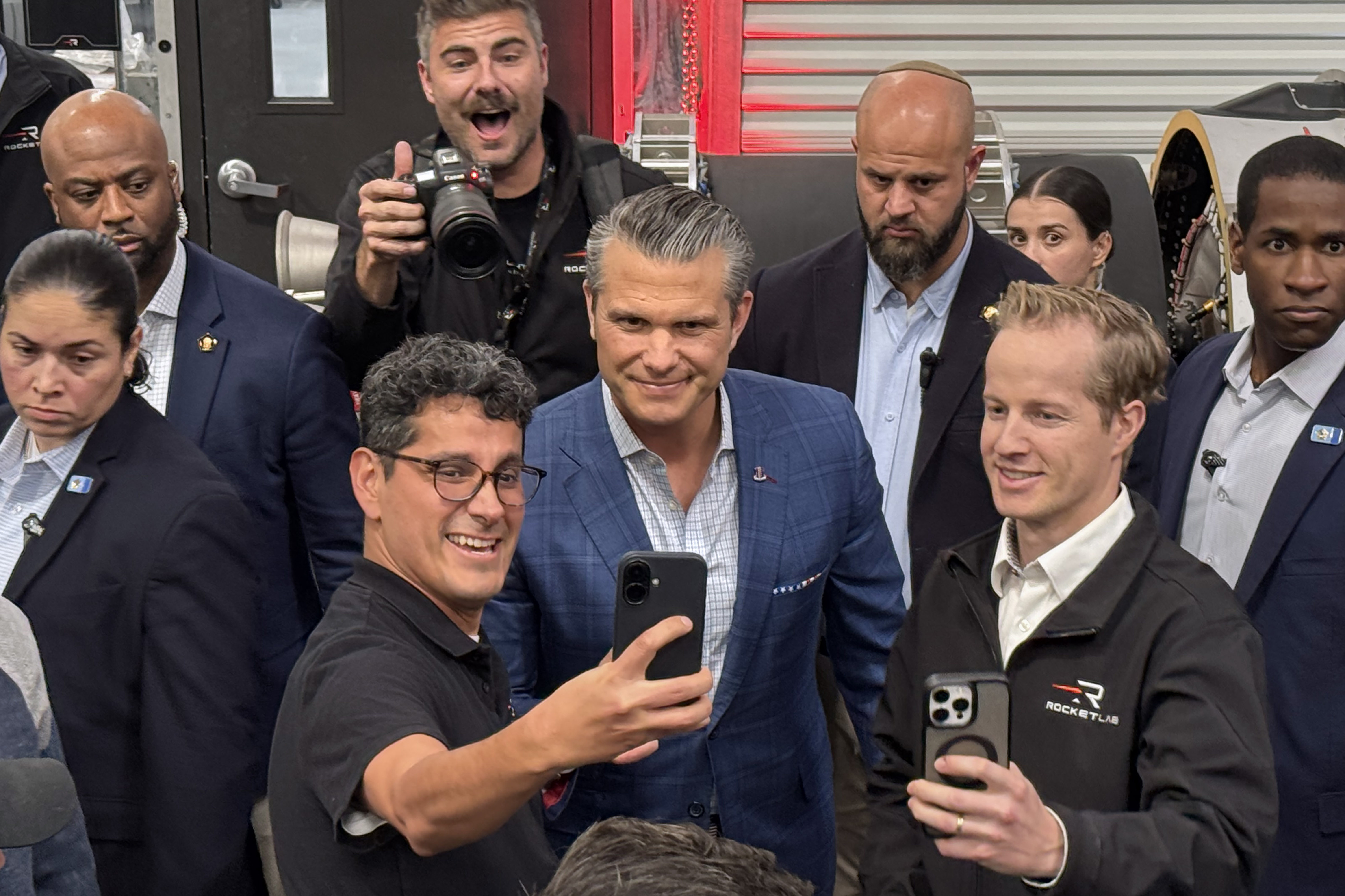 Defense Secretary Pete Hegseth, center, poses for photographs with Rocket...