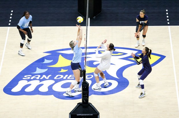 San Diego Mojo's Morgan Lewis, center, sets the ball as she and teammates go through drills during practice at Viejas Arena on Thursday, Feb. 22, 2024 in San Diego, CA. (Meg McLaughlin / The San Diego Union-Tribune)
