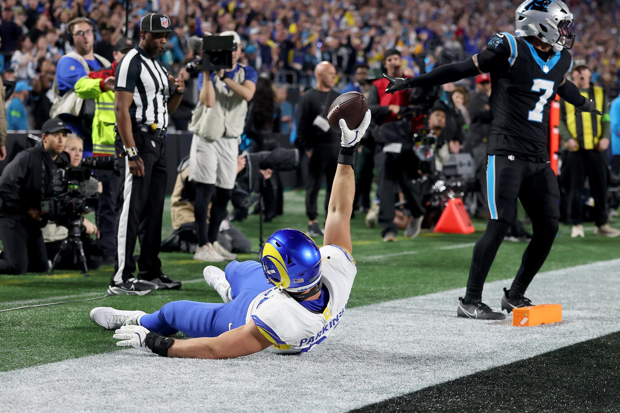 Rams tight end Colby Parkinson celebrates after making a 19-yard touchdown catch in front of Carolina safety Tre'von Moehrig.