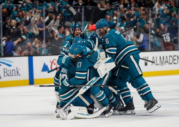 The San Jose Sharks dogpile over San Jose Sharks' Alex Nedeljkovic (33) after San Jose Sharks' Tyler Toffoli (73) scores the game winning goal against the Dallas Stars during overtime at SAP Center in San Jose, Calif., on Saturday, Jan. 10, 2026. (Shae Hammond/Bay Area News Group)