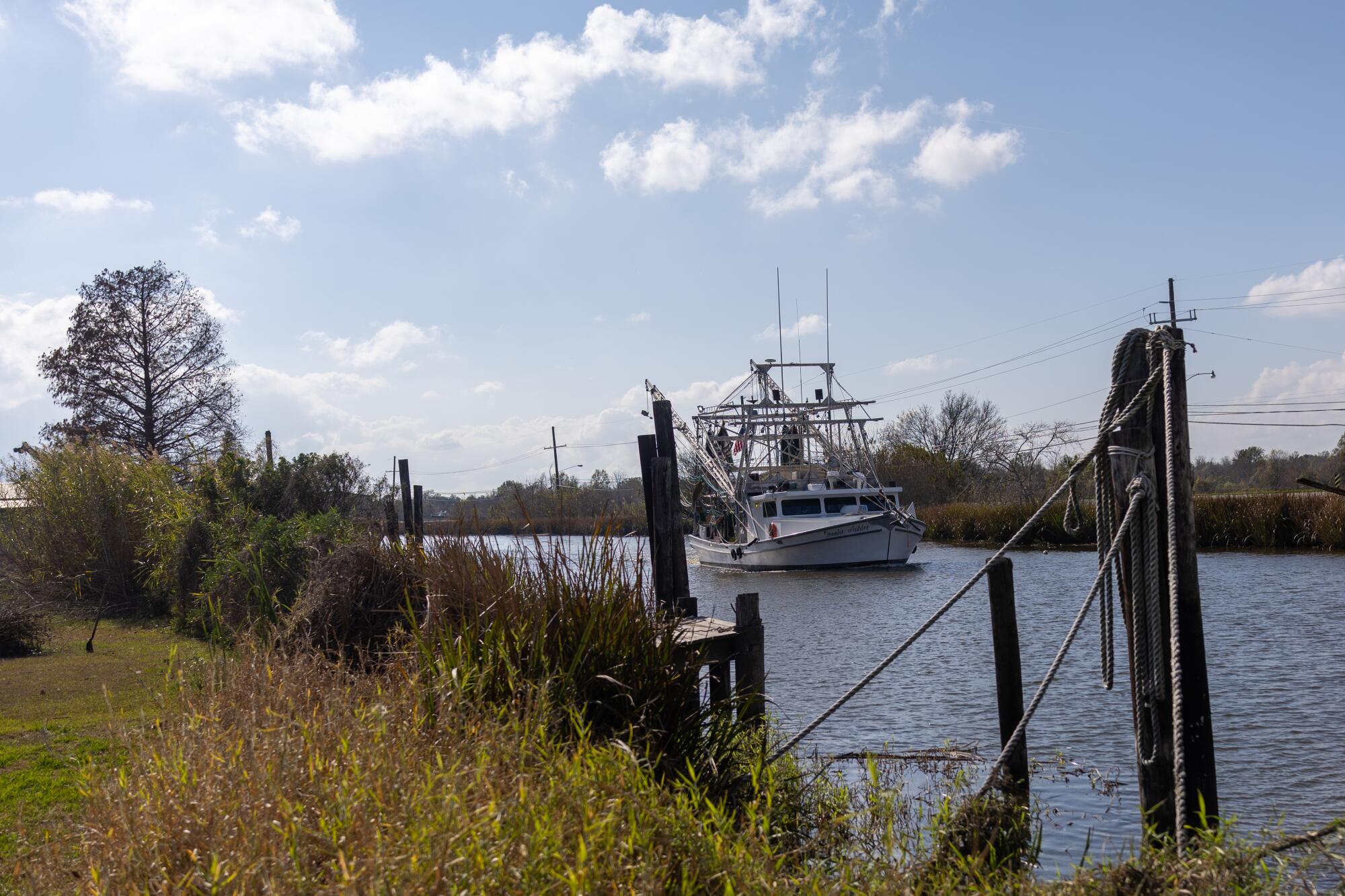 A boat moves up a canal in Chauvin, La.