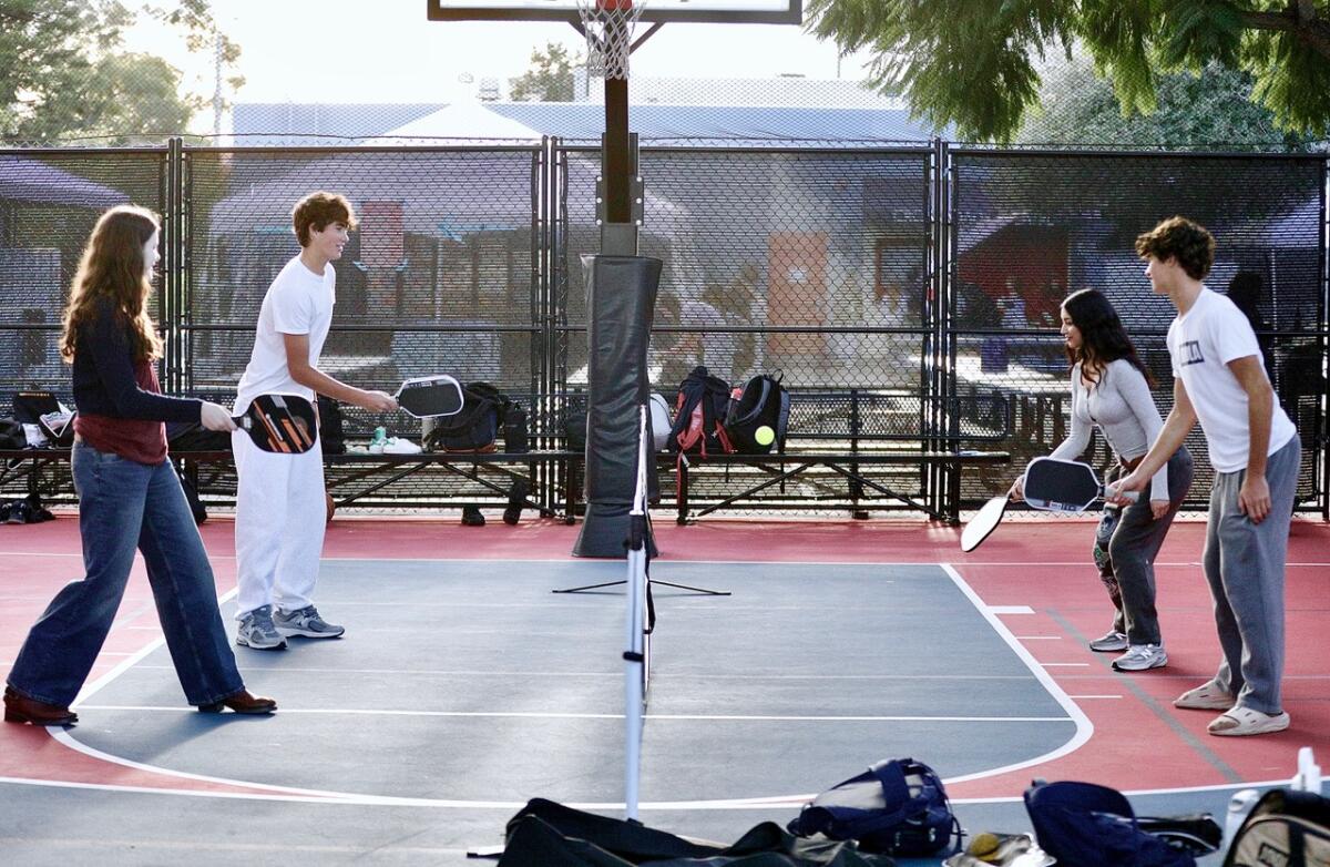 The four founders of the L.A. High School Pickleball League play mixed doubles.