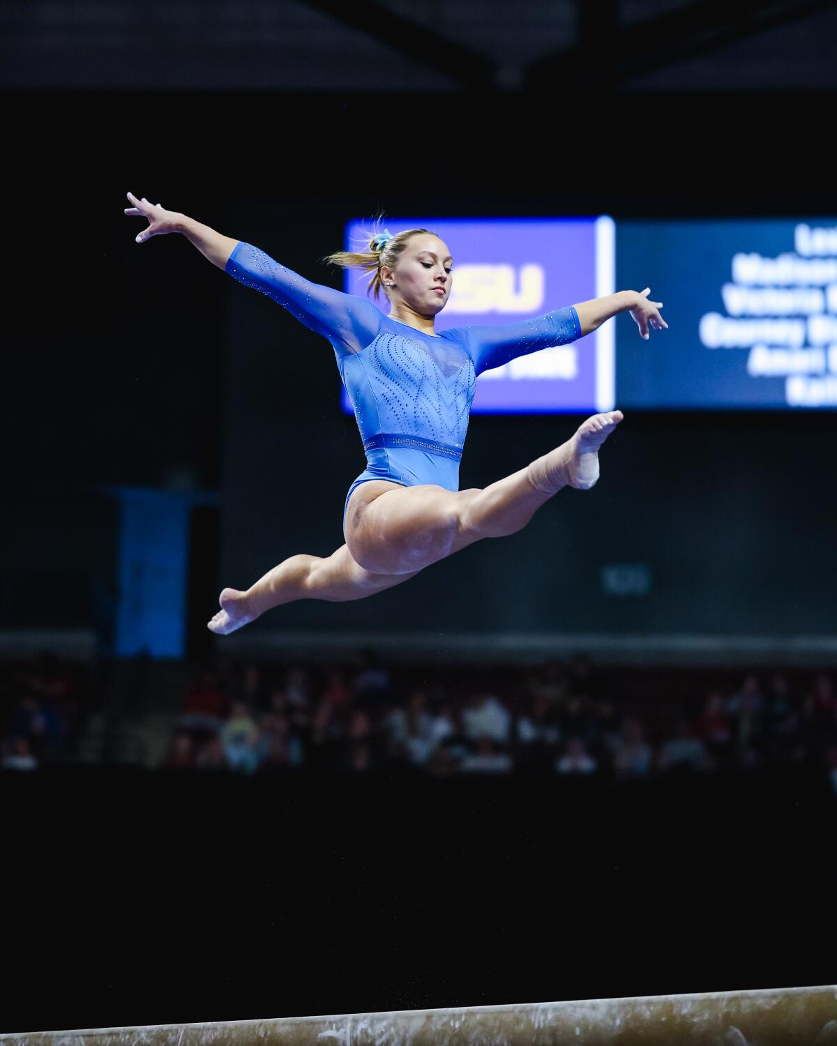 Katelyn Rosen does the splits in the air while competing on the beam during the Collegiate Quad meet.