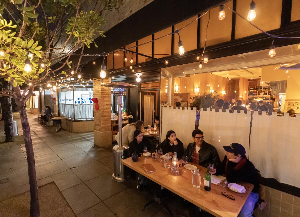 Diners at a table outside the restaurant Betsy in Altadena.