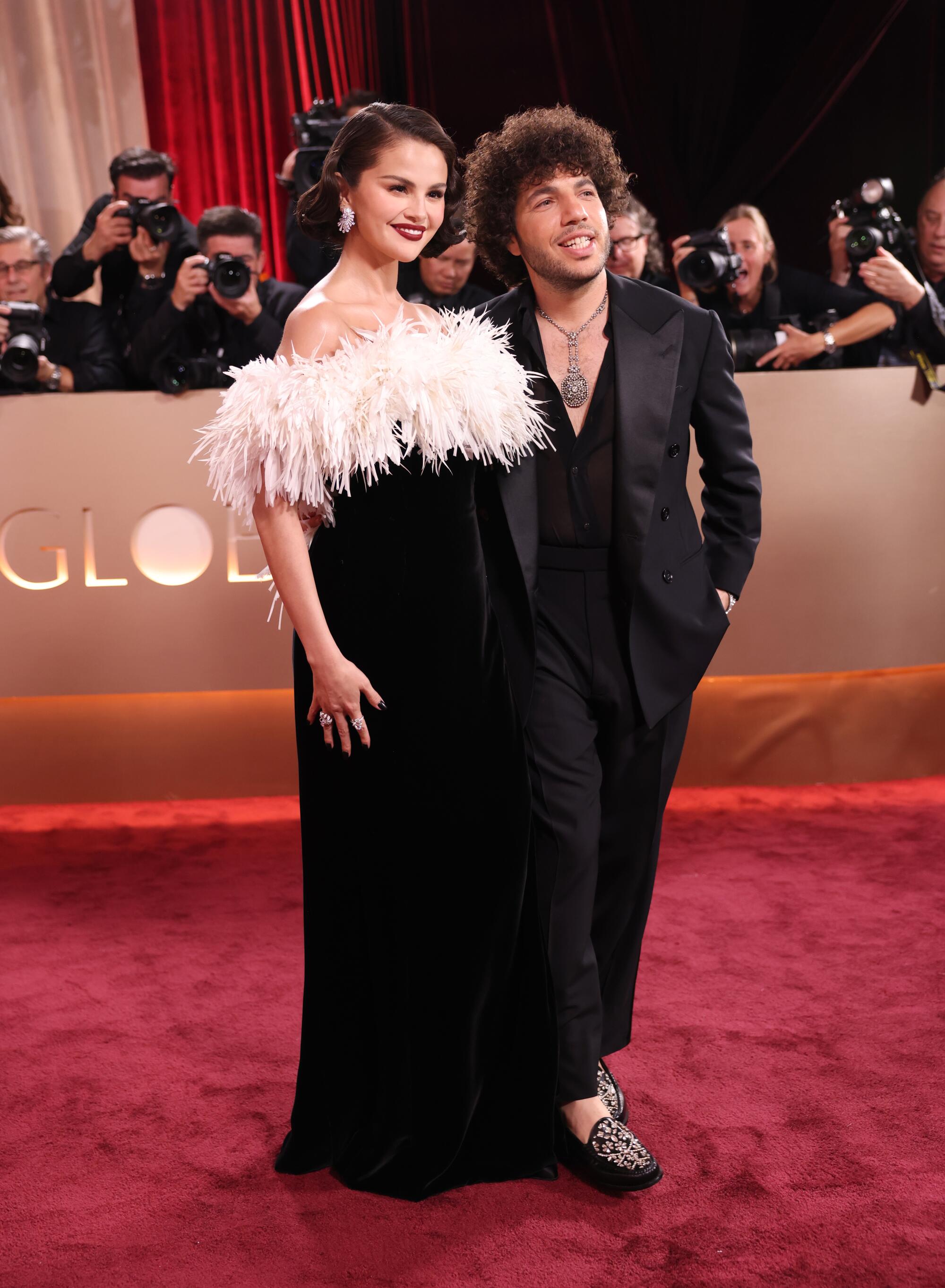 Selena Gomez and Benny Blanco pose on the red carpet. 