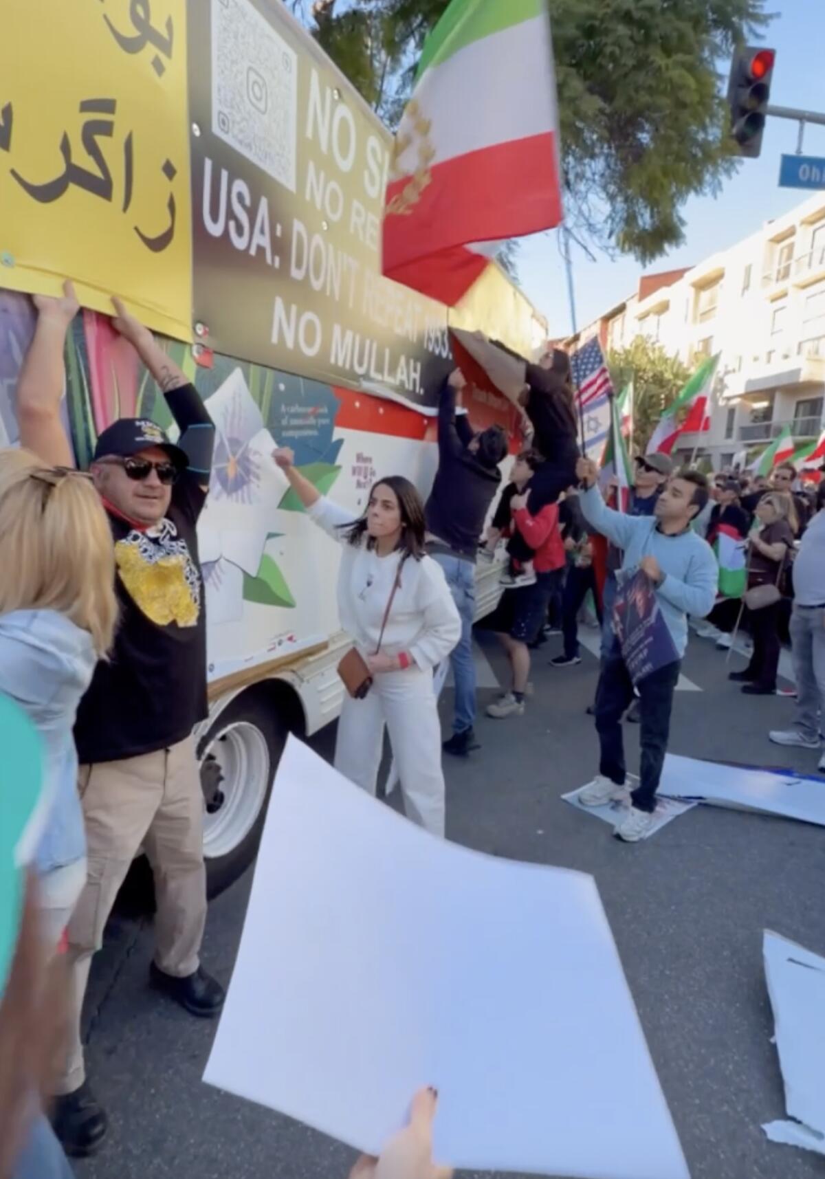 Protesters stand next to a U-Haul truck.