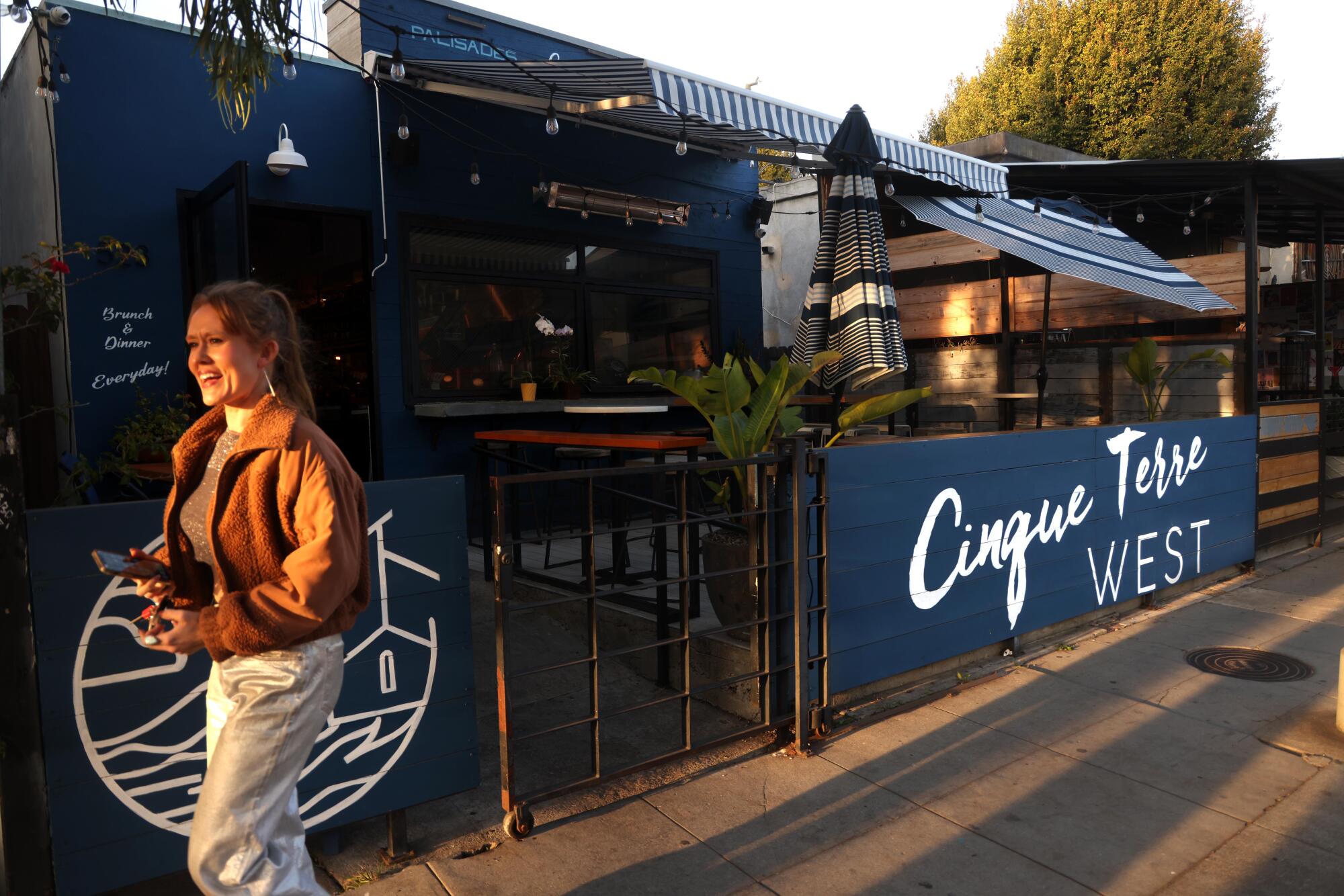 A pedestrian walks past Cinque Terre West on Rose Avenue in Venice