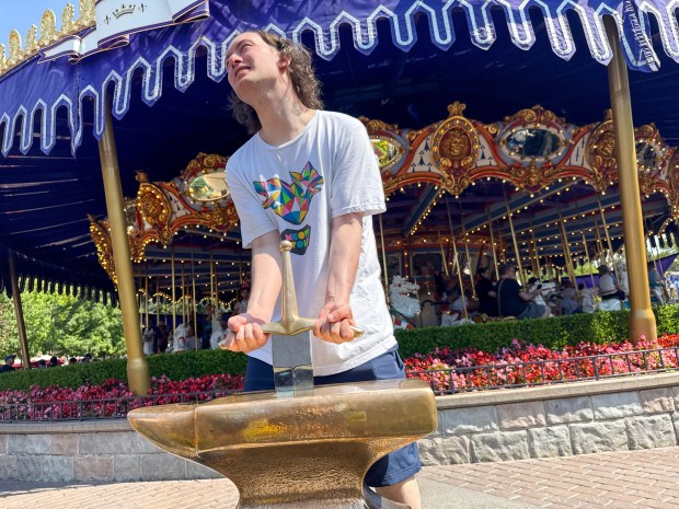 Austin Curtis tries, but fails, to pull the Sword in the Stone during the 70th anniversary Disneyland on July 17, 2025, ￼ in Anaheim, CA. ￼ (Photo by Jeff Gritchen, Orange County Register/SCNG)