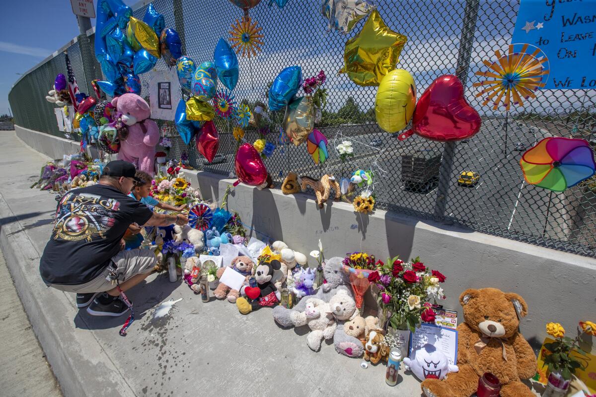 May 2021 photo of a makeshift memorial of balloons, toys, cards and candles to remember a 6-year-old Aiden Leos.