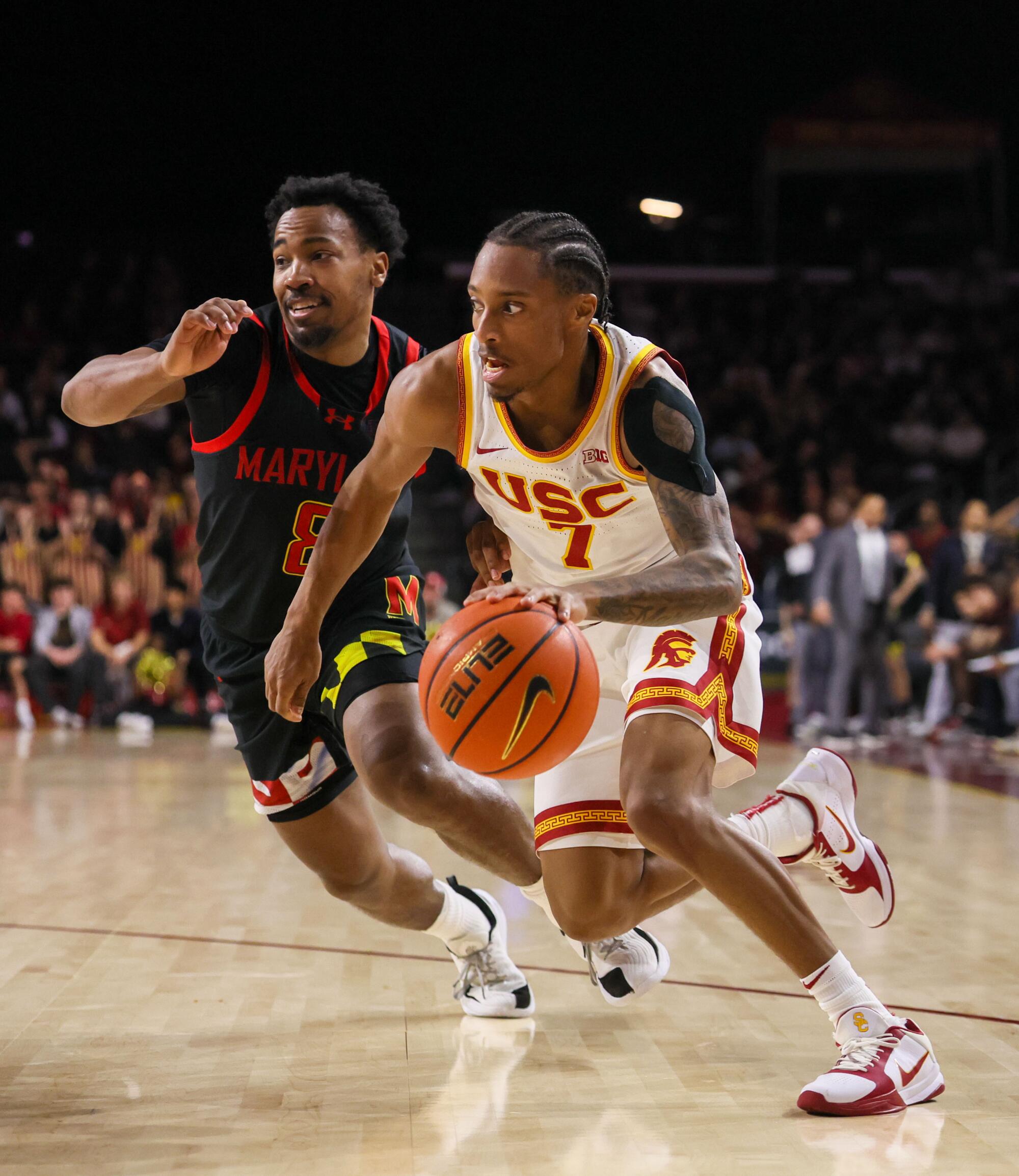 USC guard Jordan Marsh drives toward the basket under pressure from Maryland guard David Coit at Galen Center Tuesday.