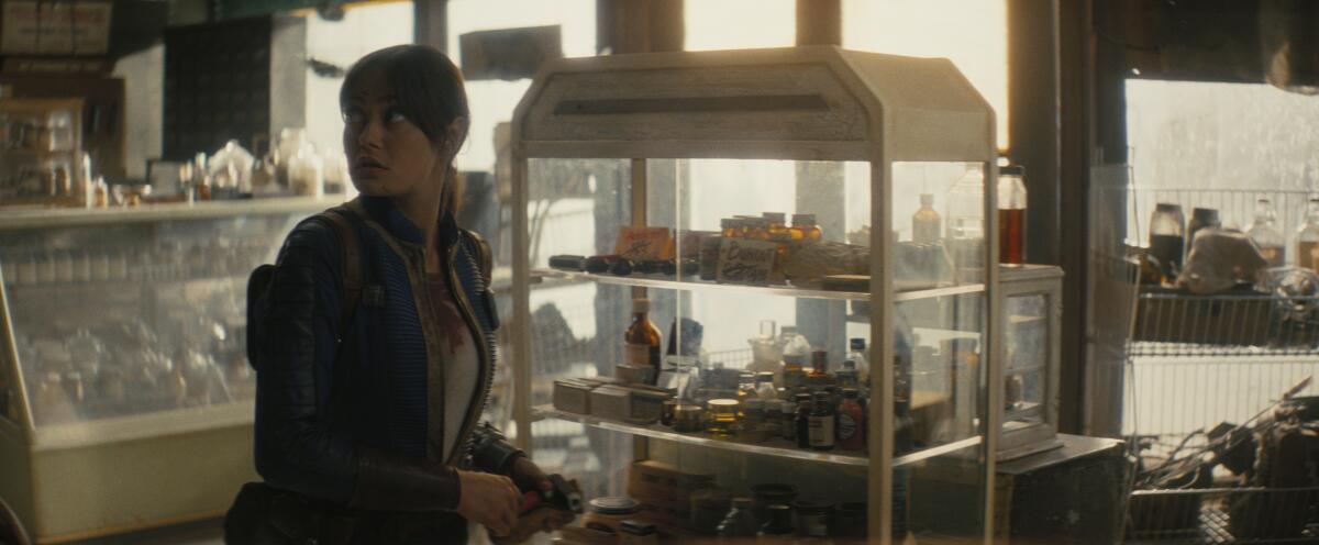a woman standing near a display case in a general store