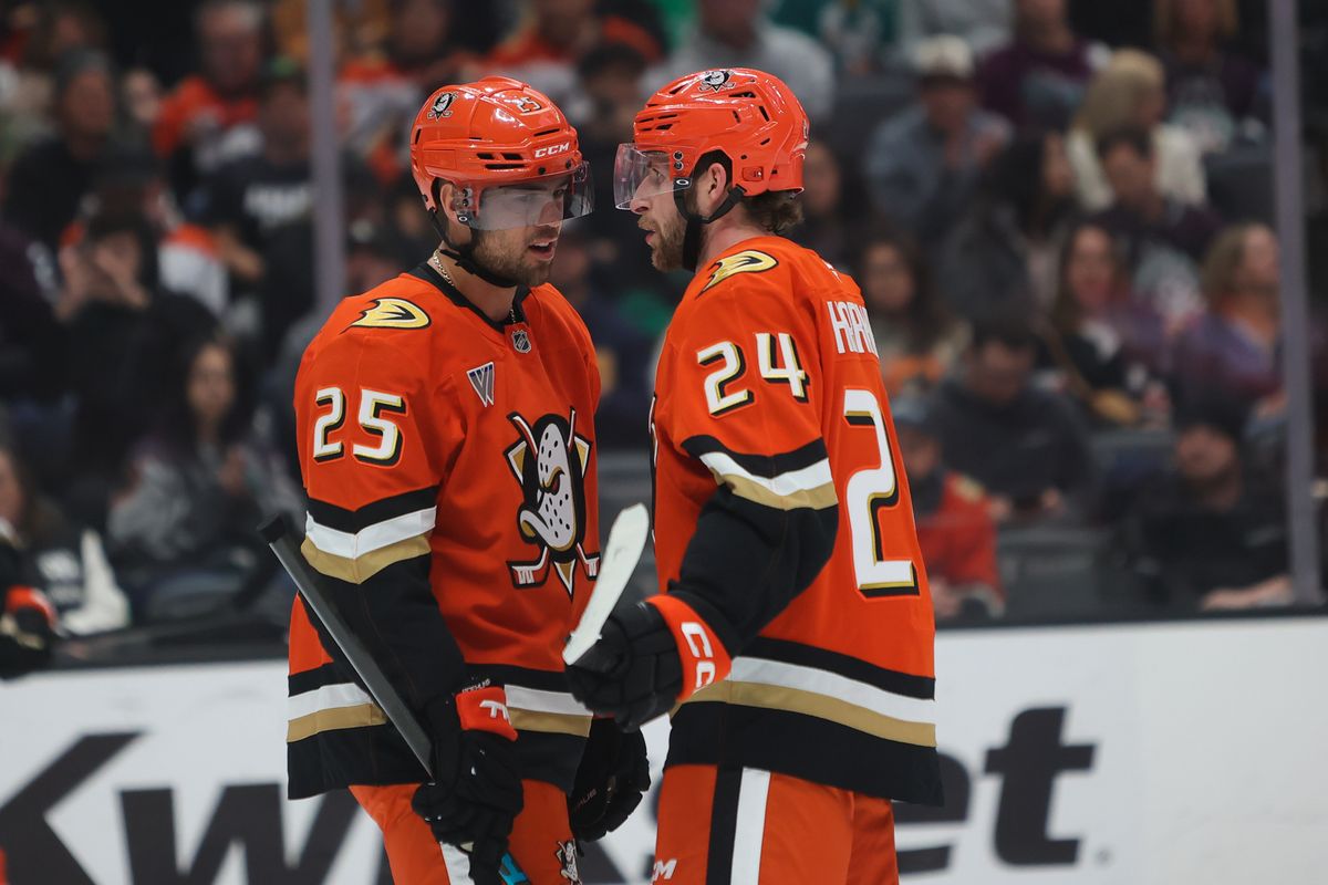 Anaheim Ducks center Ryan Poehling (25) and center Jansen Harkins (24) discuss strategy during an NHL game against the Dallas Stars on January 13, 2026 in Anaheim, CA.