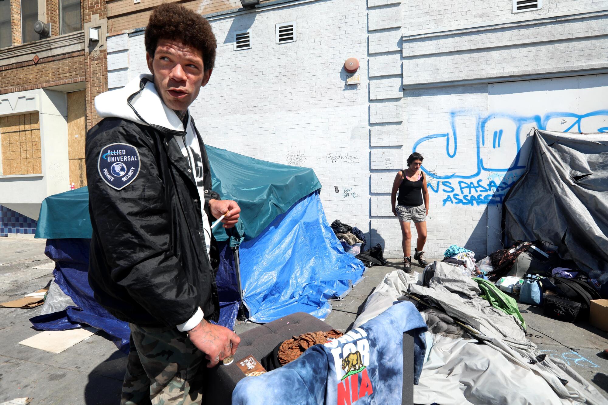 Colby Johnson in front of his tent in Skid Row in downtown Los Angeles.