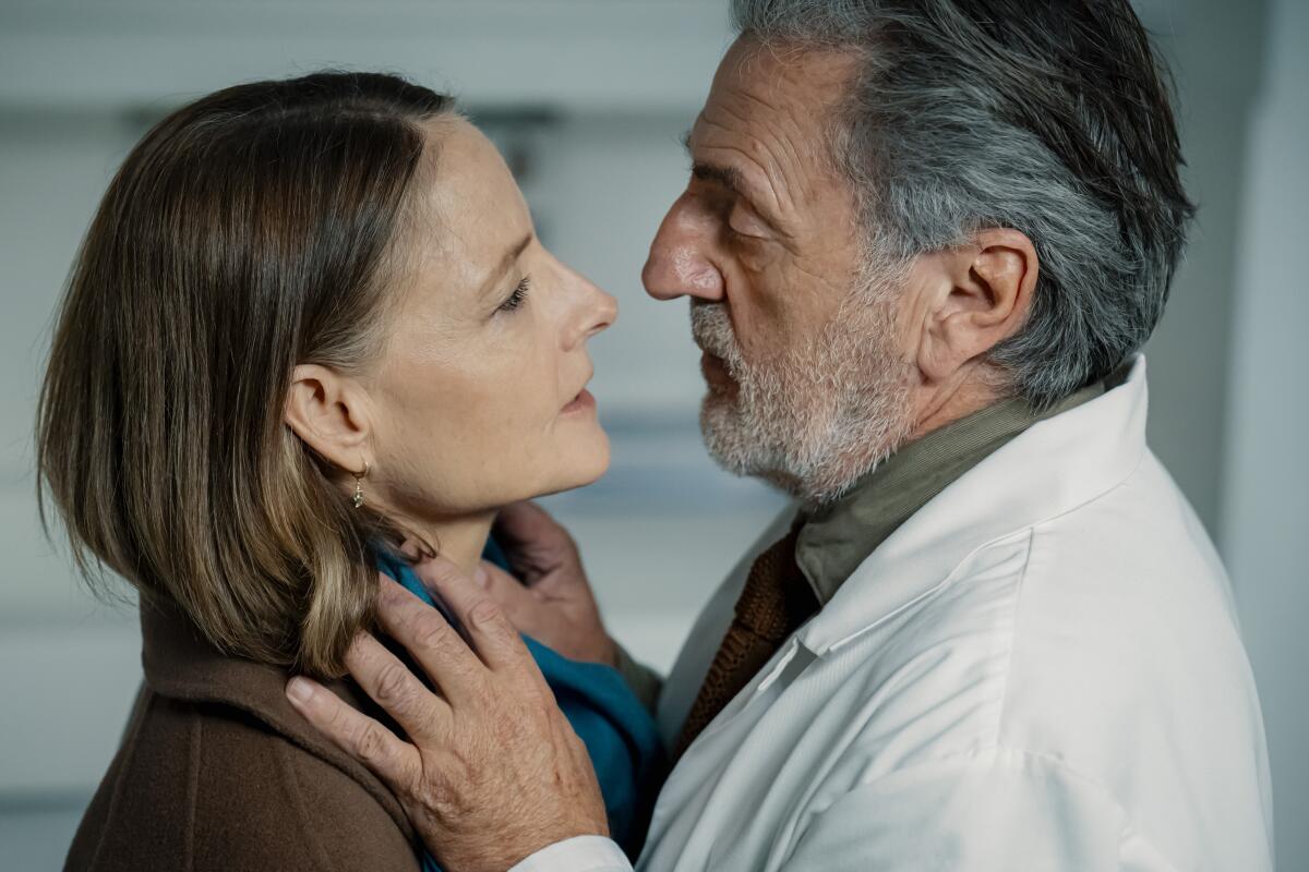 A woman is examined closely by a doctor, also her ex-husband.