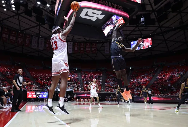 Nov 3, 2025; Salt Lake City, Utah, USA; Utah Utes forward Kendyl Sanders (13) shoots over San Jose State Spartans forward Yaphet Moundi (32) during the second half at Jon M. Huntsman Center.
