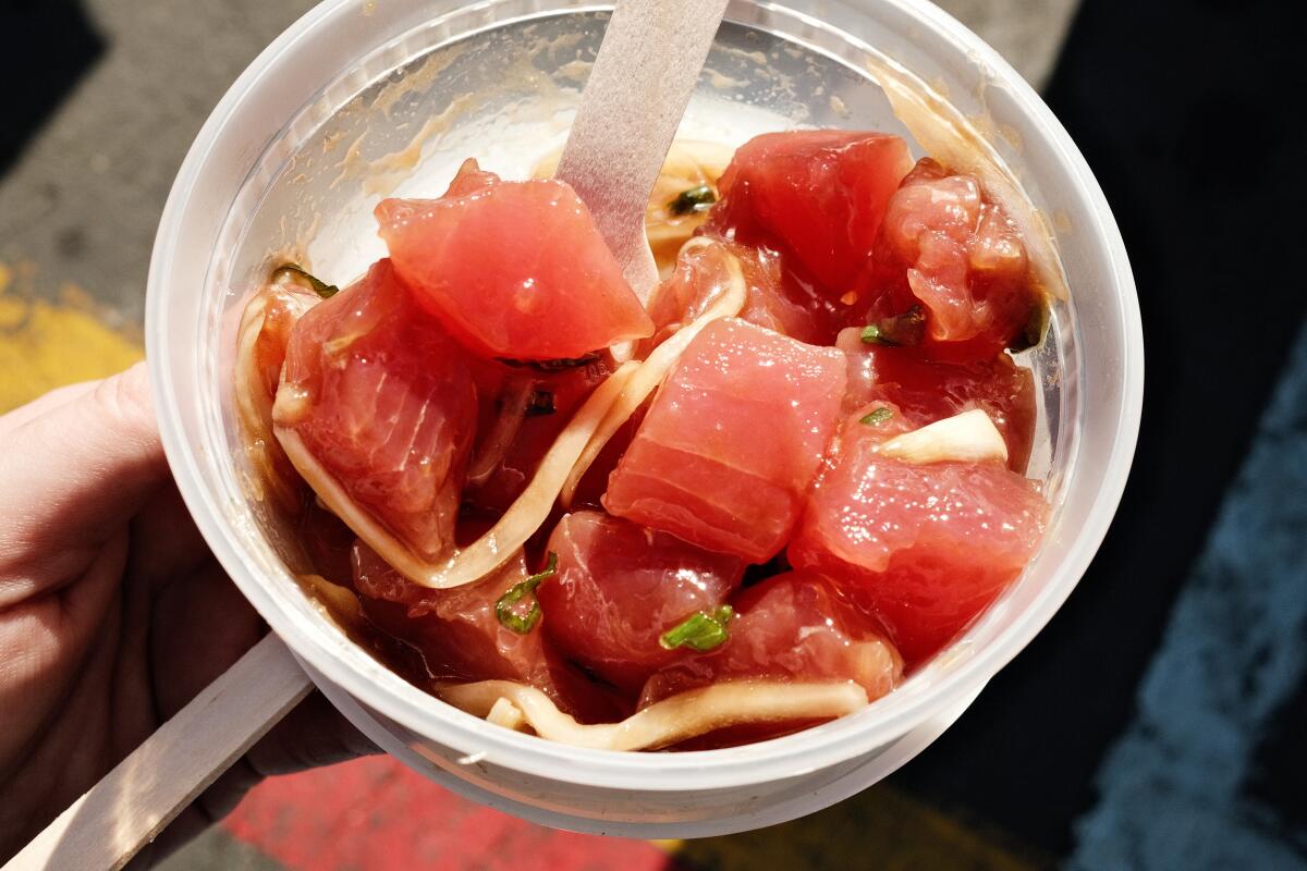 Cubes of shoyu tuna poke in a plastic container