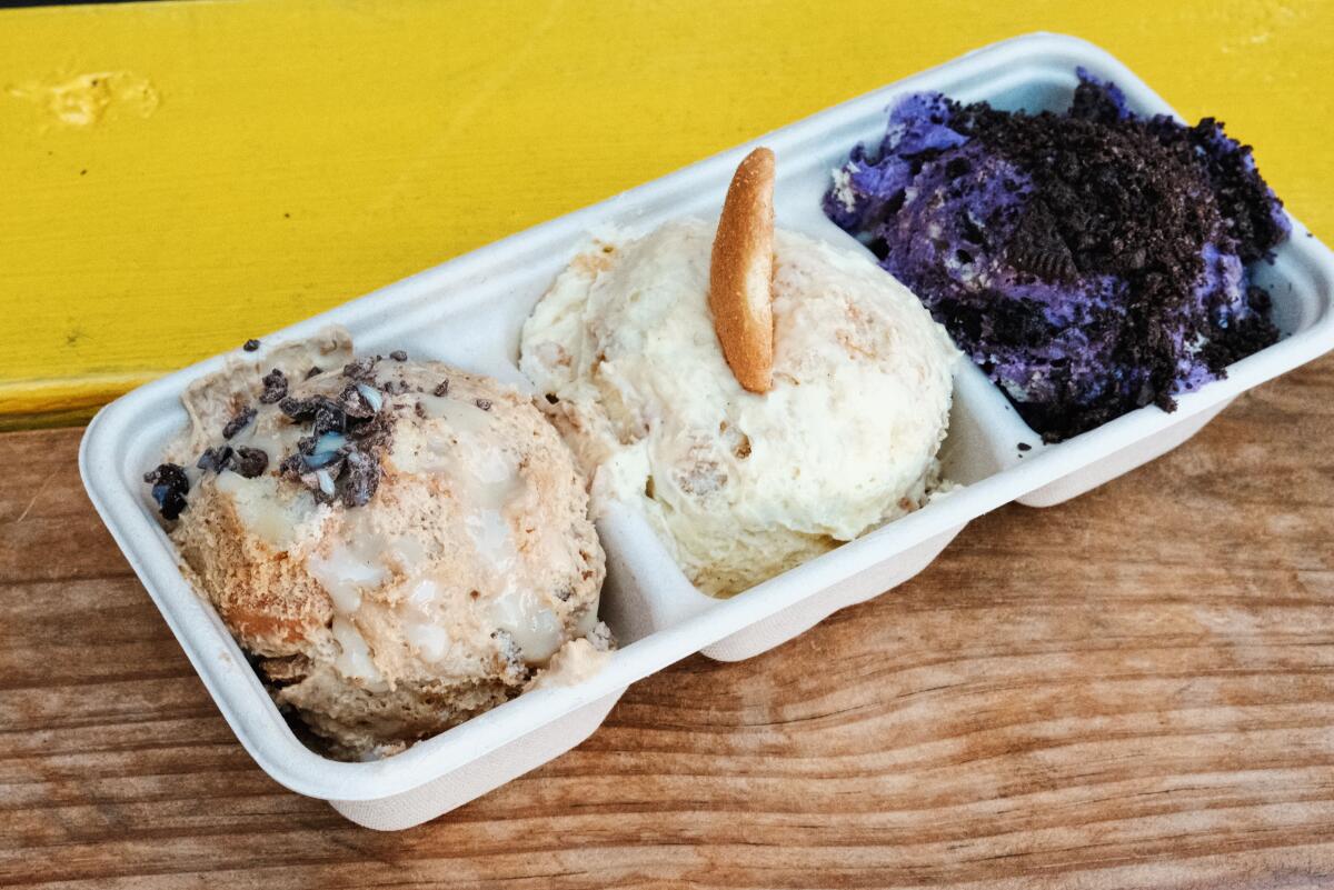 A trio of scoops of banana puddings from Banana Mama on a wood table