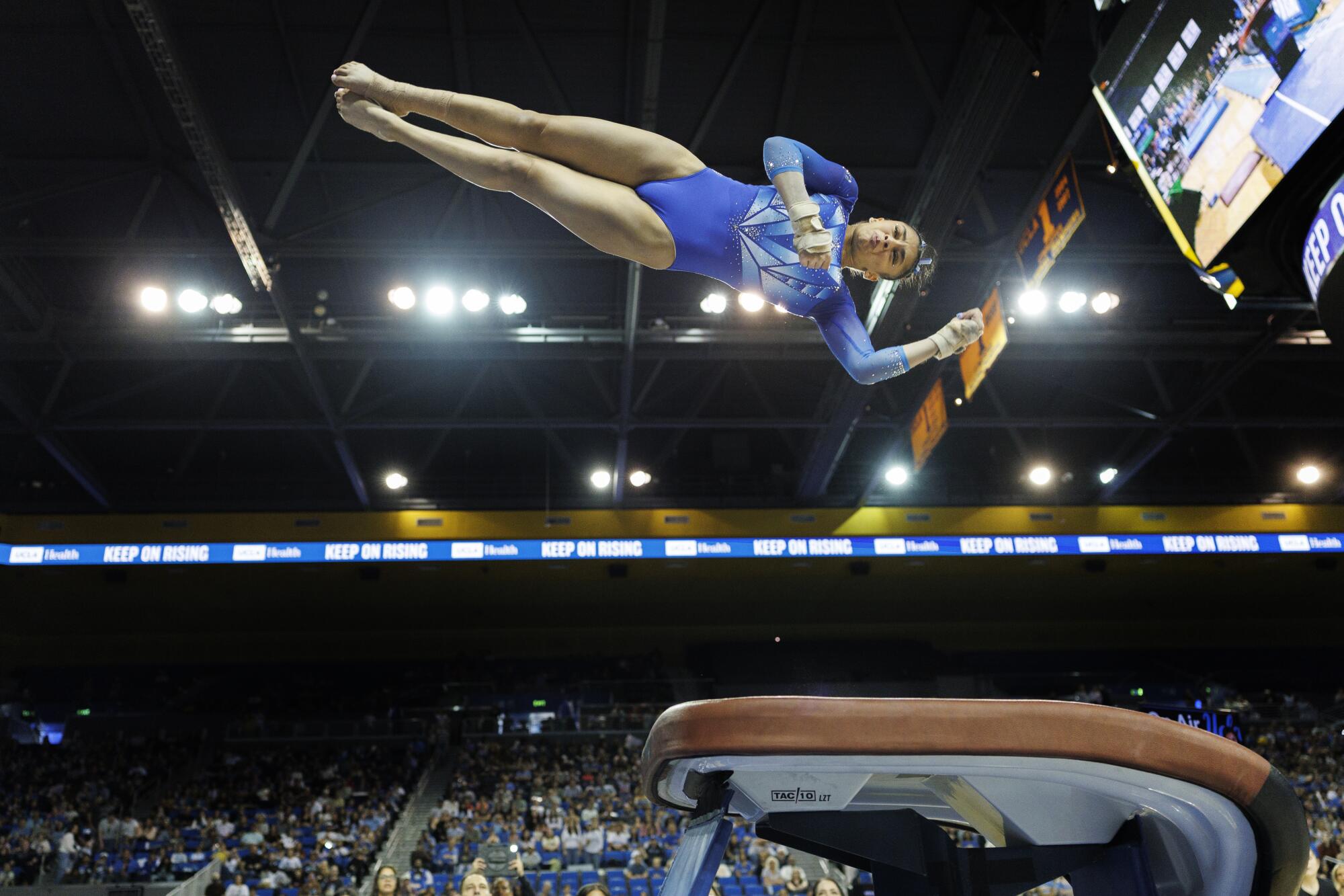 UCLA's Tiana Sumanasekera rotates high over the vault during a meet against Nebraska at Pauley Pavilion on Saturday.