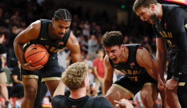 Purdue guard Jack Benter, center bottom, is congratulated by guards C.J. Cox, left, Omer Mayer (17) and Braden Smith, right, after blocking a shot by Southern California guard Jordan Marsh during the second half of an NCAA college basketball game Saturday, Jan. 17, 2026, in Los Angeles. (AP Photo/Caroline Brehman)